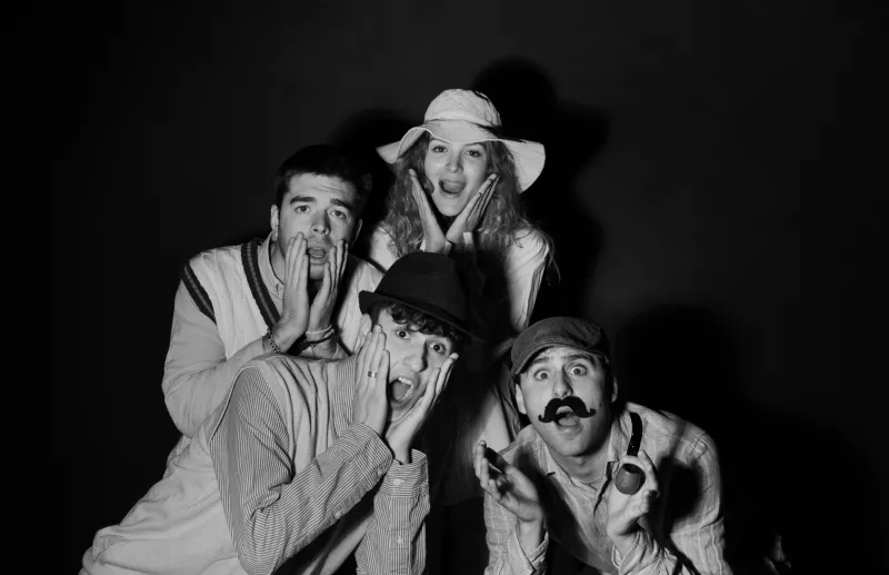 A startled group of five in black and white, against a dark background