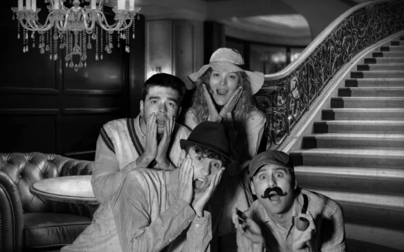 The same group in a hotel lounge under a chandelier
