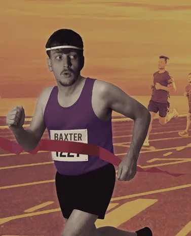 A runner crossing the finish line against a burnt-orange sky