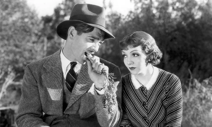 A screwball comedy still: a couple on a park bench