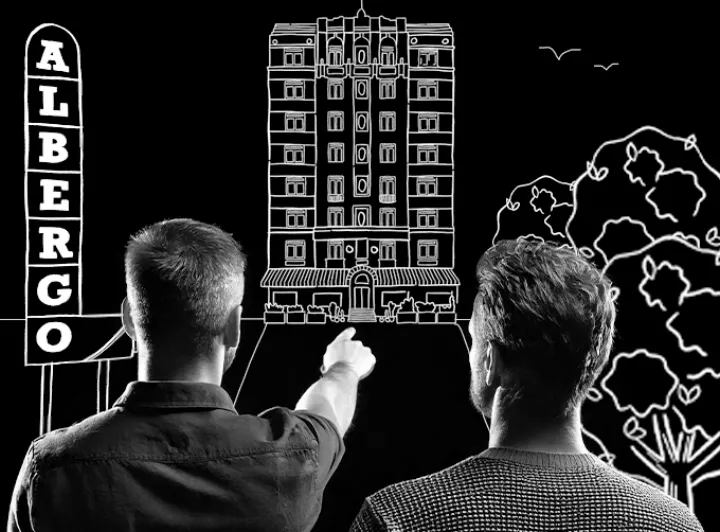 Early test: the men in front of a line drawing of the hotel