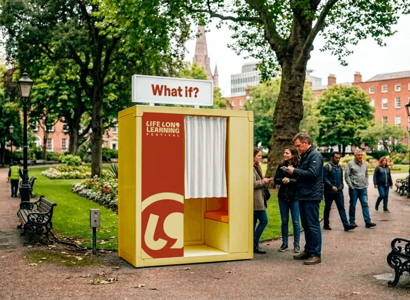 A yellow “What If?” booth installed in a Dublin park