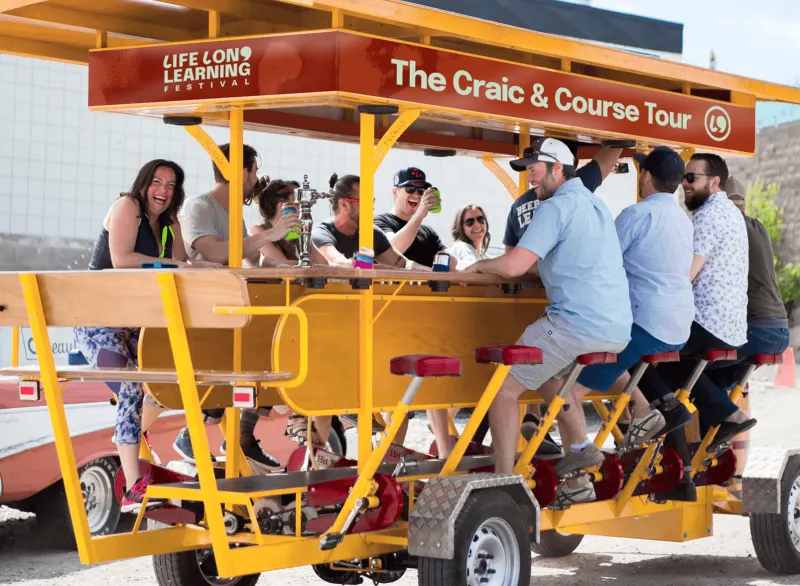 The Craic and Course Tour vehicle, a pedal bar packed with people