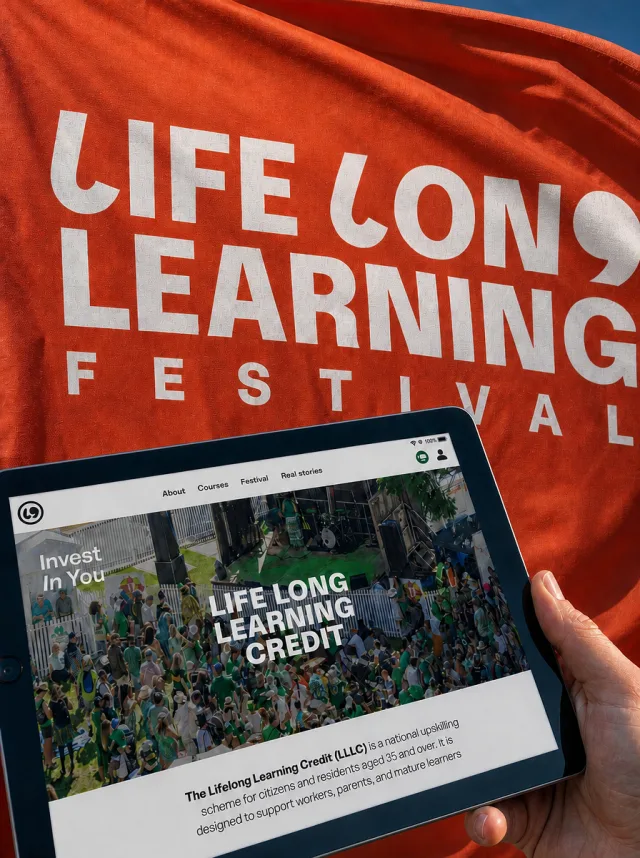 A hand holding a tablet showing the Lifelong Learning Credit website, in front of a Lifelong Learning Festival flag