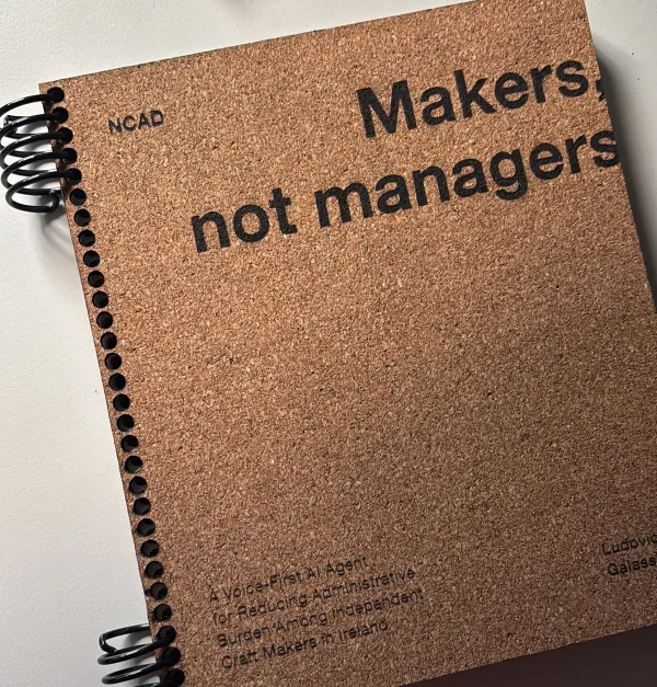 The thesis book: a spiral-bound cork cover reading “Makers, not managers”