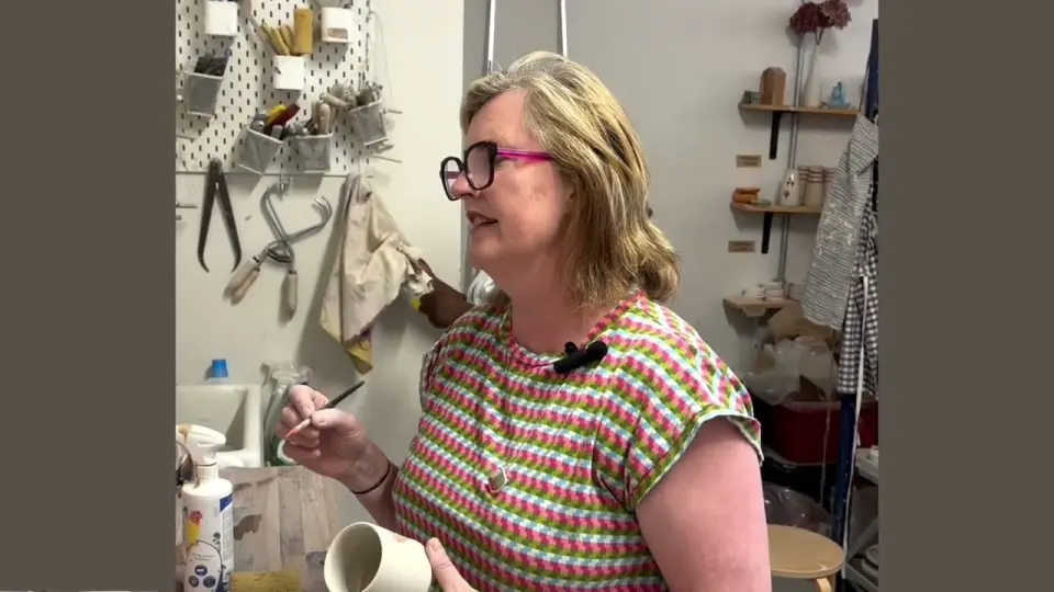 A ceramicist in her studio, wearing the Lugh clip microphone while she works