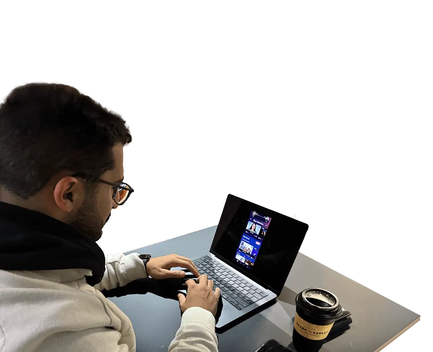 A person testing the digital prototype on a laptop, coffee beside him