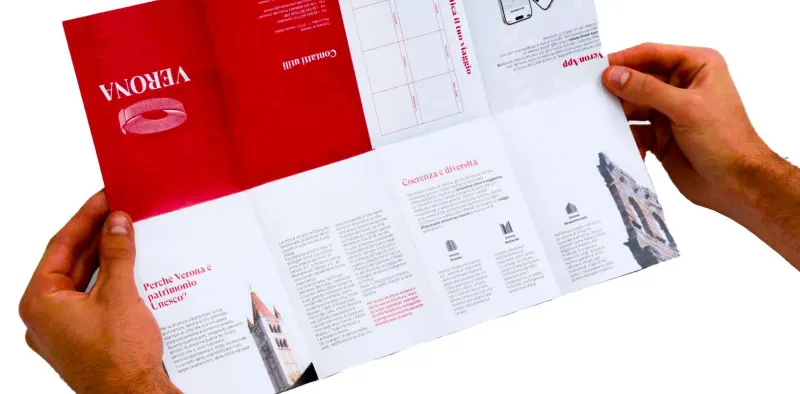 Hands opening the brochure to a map spread