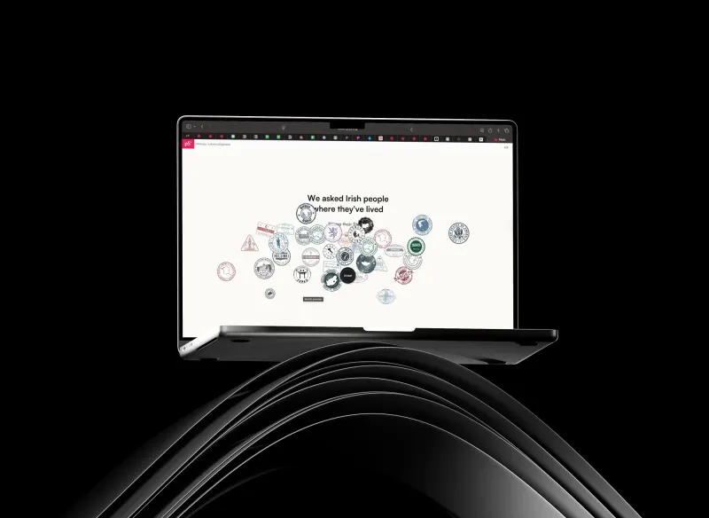 The experience on a laptop: “We asked Irish people where they've lived”, a cluster of flags and circles